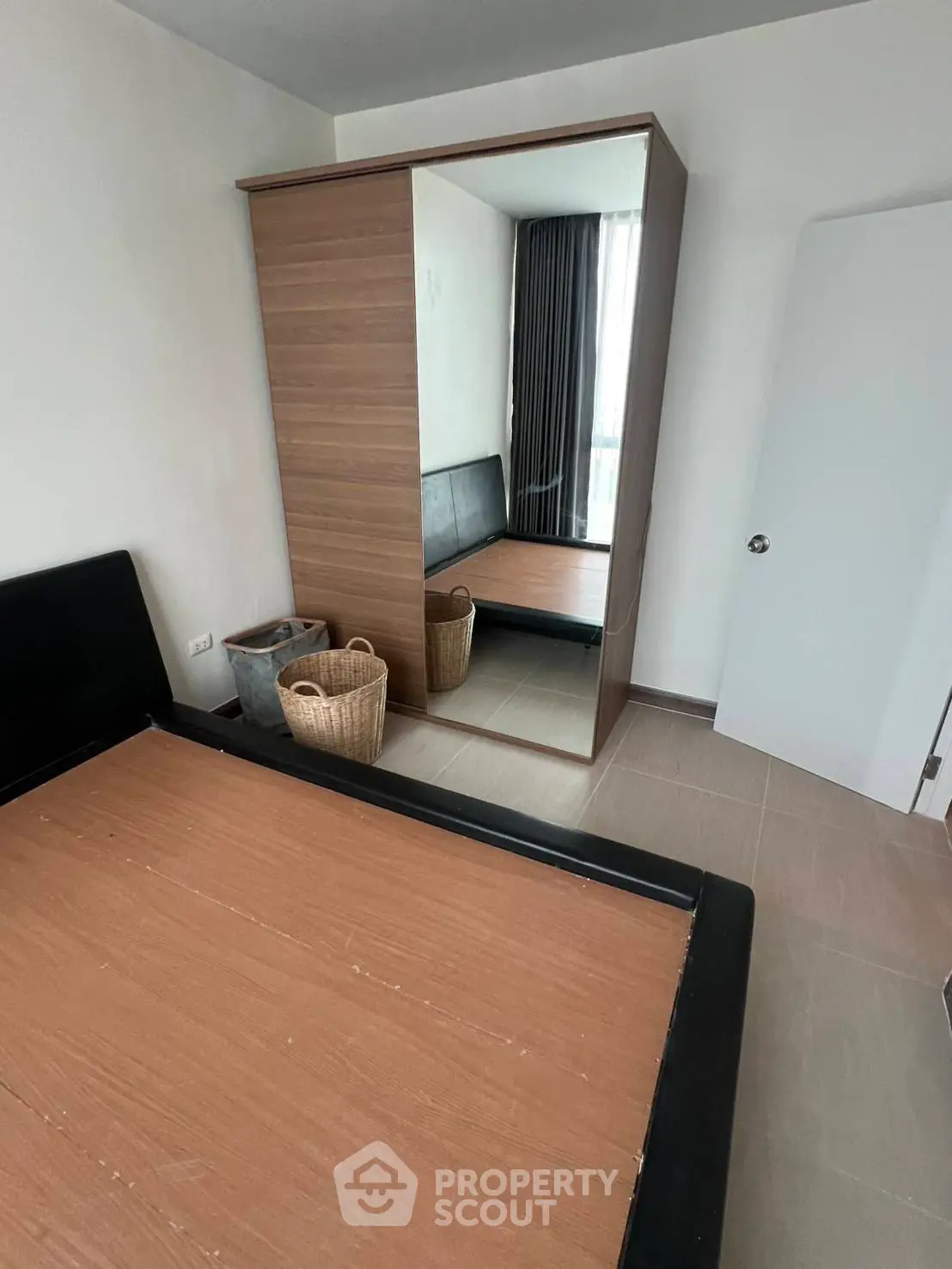 Spacious bedroom with mirrored wardrobe and modern design