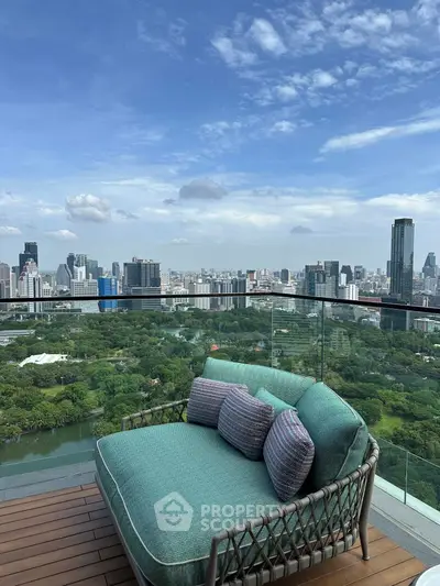 Stunning cityscape view from a luxurious balcony with modern seating.
