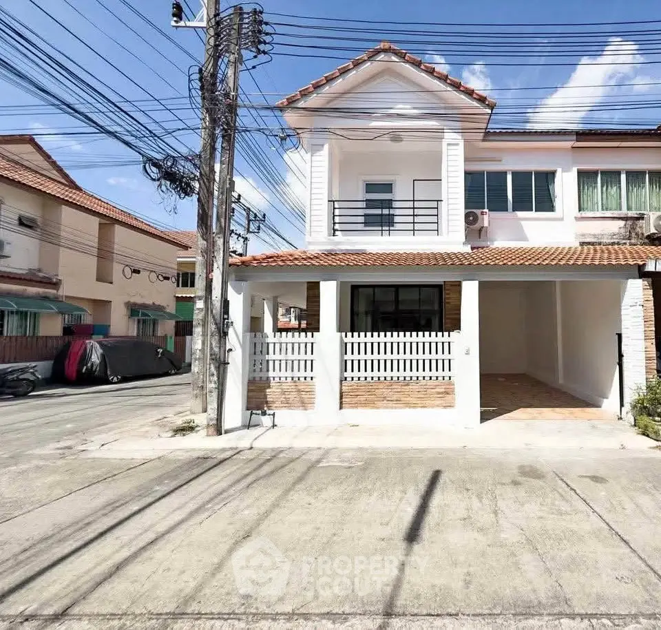 Charming two-story house with tiled roof and spacious driveway in a serene neighborhood.