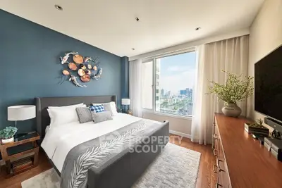 Luxurious bedroom with city view, modern decor, and elegant furnishings in a high-rise apartment.