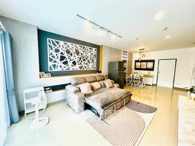 Spacious modern living room with stylish decor and comfortable seating in a bright apartment.