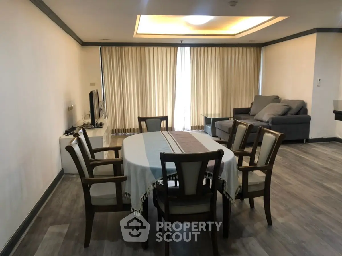 Spacious living room with elegant dining area and cozy seating, perfect for entertaining guests.