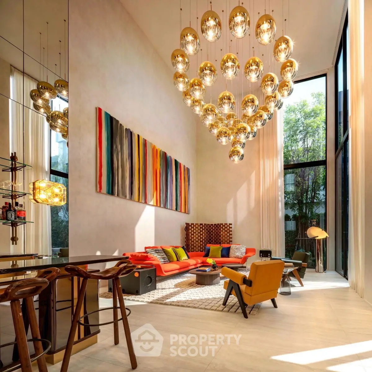 Luxurious modern living room with high ceilings, vibrant decor, and stunning chandelier lighting.