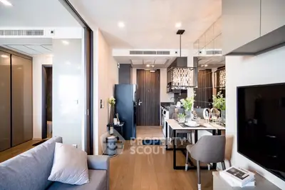 Elegant open-plan living space with a seamless transition to a modern kitchen, featuring high-end finishes and a sophisticated neutral palette.