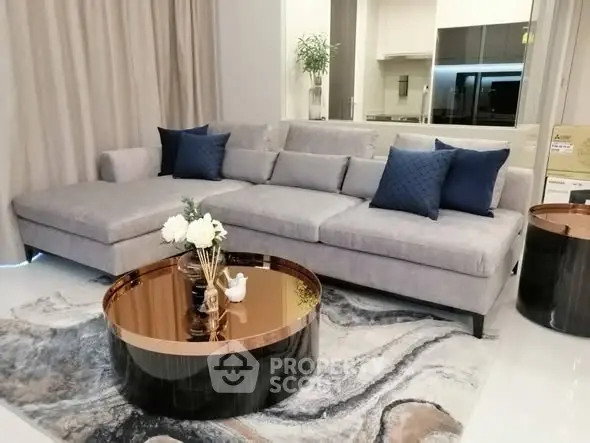 Modern living room with stylish gray sofa and elegant coffee table in a chic apartment.