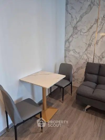 Modern living room with marble accent wall and stylish furniture