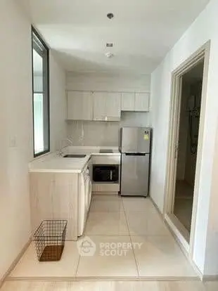 Modern kitchen with sleek appliances and minimalist design in a compact layout.