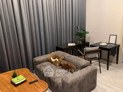 Modern living room with stylish furniture and elegant decor, featuring a cozy sofa and a sleek work desk.
