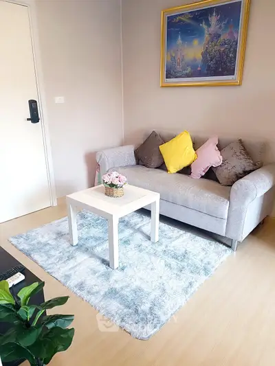 Cozy living room with plush sofa, vibrant cushions, and elegant decor in a modern apartment.
