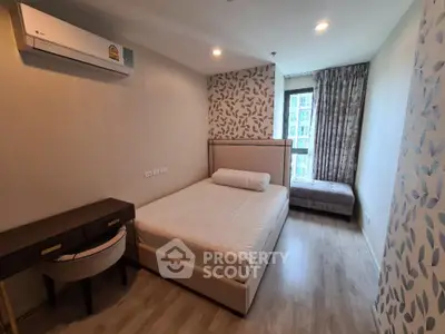 Modern bedroom with stylish decor, featuring a comfortable bed, desk, and large window with city view.