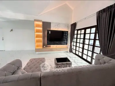 Spacious living room with modern decor and large windows for natural light.