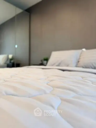 Luxurious bedroom with plush bedding and modern decor, perfect for relaxation and comfort.
