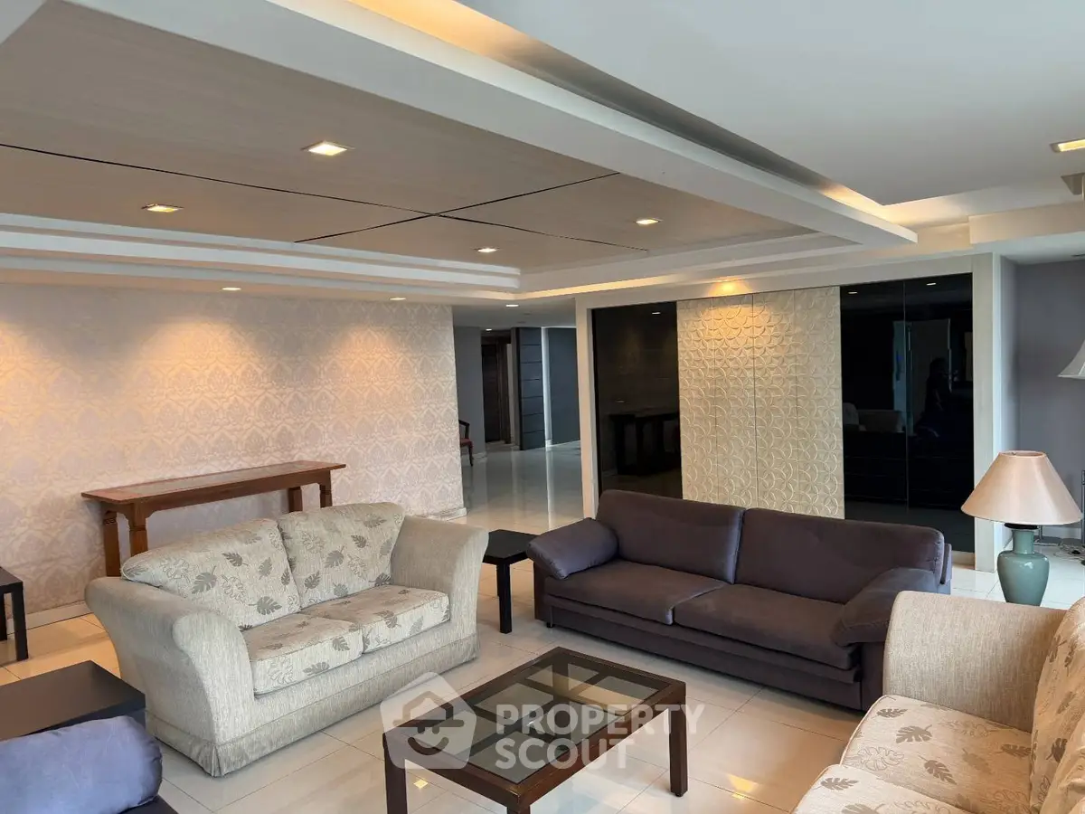 Spacious living room with modern decor and elegant lighting