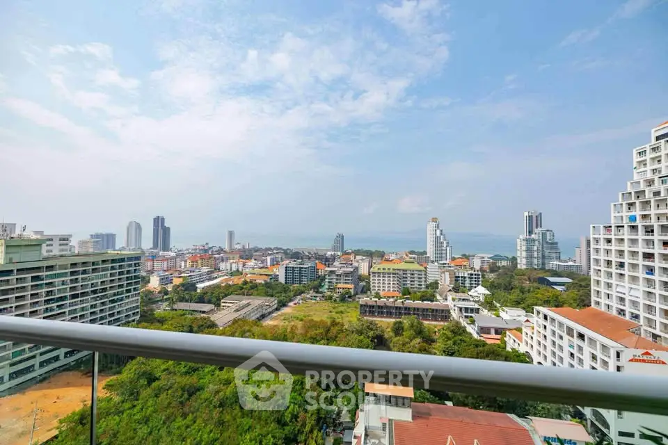 Stunning cityscape view from a high-rise balcony overlooking urban skyline and distant ocean.