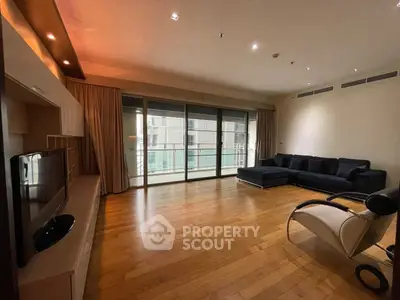 Spacious modern living room with hardwood floors and large windows