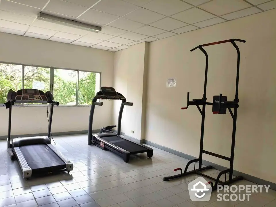 Spacious gym with modern treadmills and exercise equipment, ideal for fitness enthusiasts.