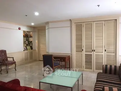 Spacious living room with elegant furniture and ample natural light.