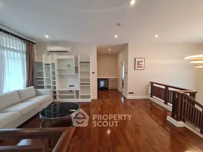 Spacious living room with hardwood floors and modern furniture