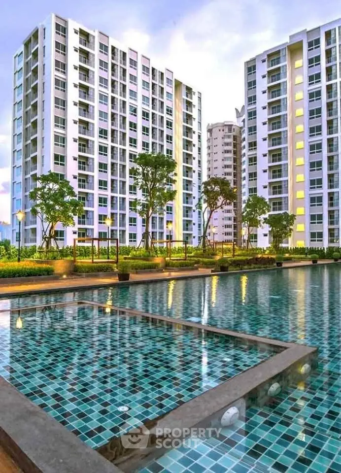 Luxurious high-rise apartment complex with stunning pool and landscaped gardens.