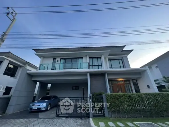 Modern two-story house with a sleek design and spacious driveway