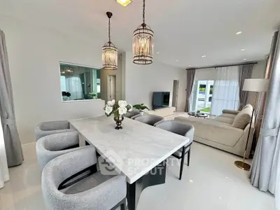 Elegant open-plan living and dining area with modern decor and natural light.