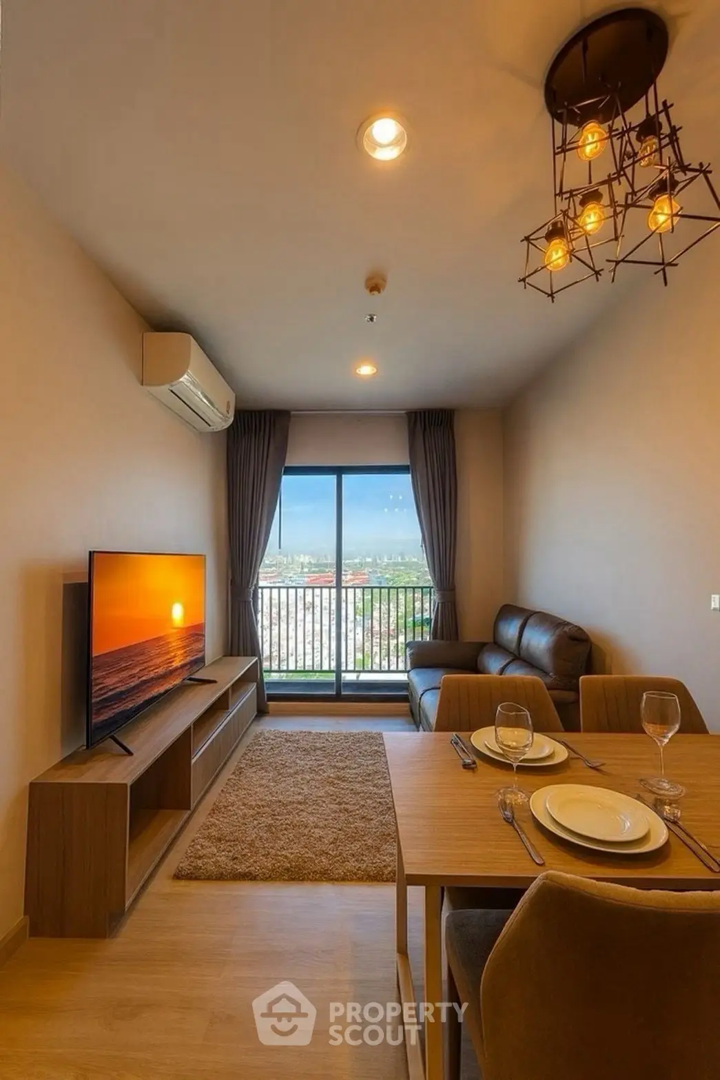 Modern living room with balcony and sunset view, featuring stylish lighting and cozy furniture.