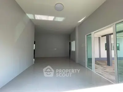 Spacious modern interior with large windows and sleek tile flooring, perfect for customization.