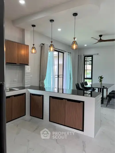 Modern kitchen with open layout and stylish lighting in a contemporary home.