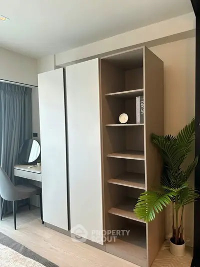 Modern bedroom with sleek wardrobe and stylish vanity desk, perfect for contemporary living.