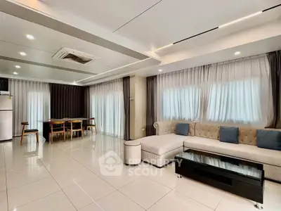 Spacious modern living room with elegant furniture and ample natural light
