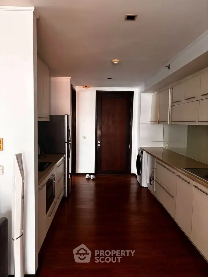 Modern kitchen with sleek cabinetry and integrated appliances in a stylish apartment.