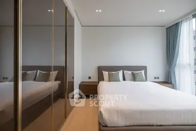 Modern bedroom with mirrored wardrobe and elegant decor