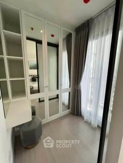Bright and modern bedroom with floor-to-ceiling windows and mirrored wardrobe.