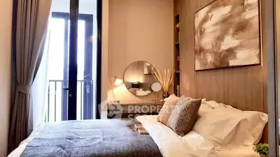 Luxurious bedroom with elegant decor and balcony access in modern apartment.