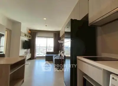 Modern open-layout living room with city view, featuring sleek kitchen and cozy seating area.