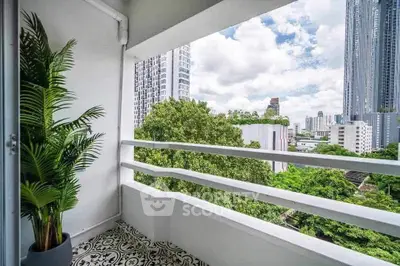 Charming balcony with city skyline view and lush greenery, perfect for relaxation and enjoying urban living.