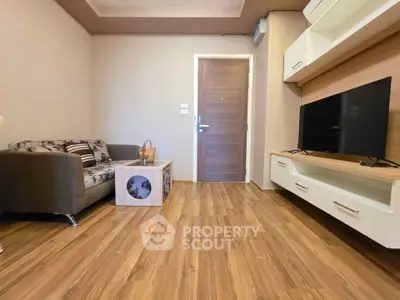 Modern living room with wooden flooring and sleek furniture