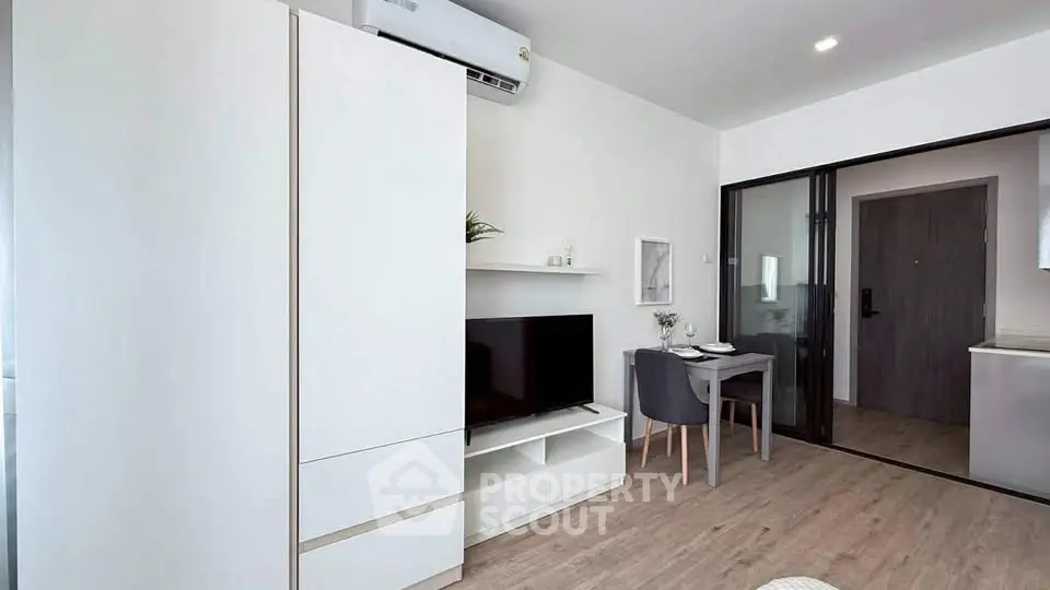 Modern living room with sleek furniture and open layout in a stylish apartment.