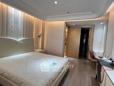 Luxurious bedroom with modern design and ambient lighting, featuring a comfortable bed and stylish decor.