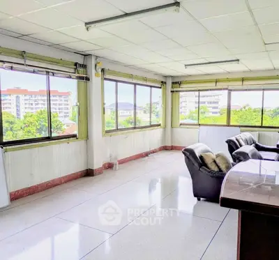 Spacious office space with large windows and natural light