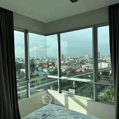 Stunning corner unit bedroom with panoramic city views and abundant natural light.