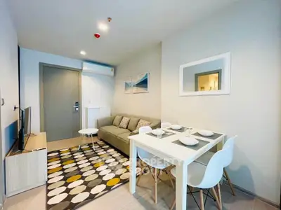Modern living room with stylish decor and dining area in a cozy apartment.