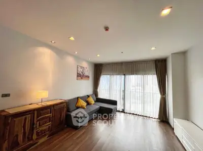 Spacious living room with modern decor and large windows offering city views.