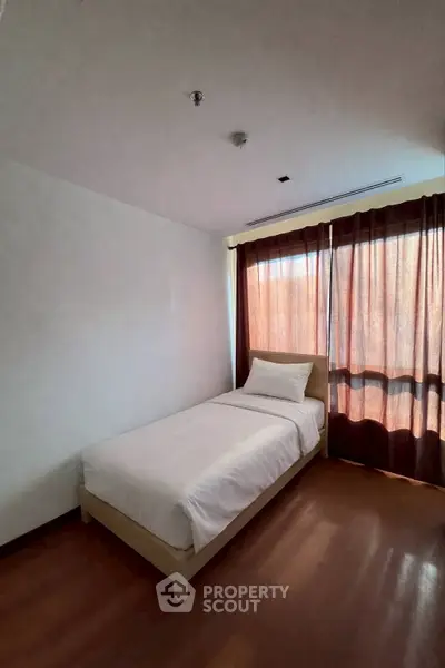 Cozy single bedroom with natural light and minimalist decor