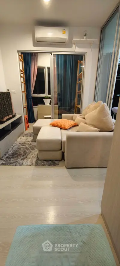 Modern living room with cozy beige sofa and stylish decor in a contemporary apartment.