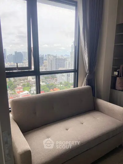 Cozy living room with stunning city view from high-rise window