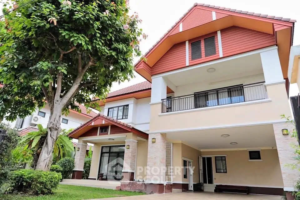 Charming two-story house with spacious balcony and lush garden, perfect for family living.