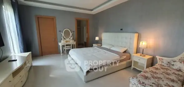 Spacious bedroom with elegant decor and natural light