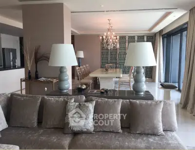 Luxurious open-plan living and dining area with elegant decor and large windows.