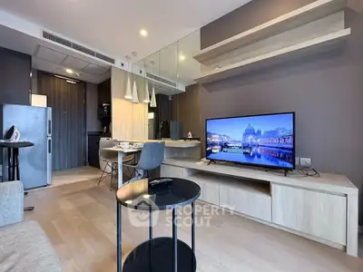 Modern living room with sleek furniture and wall-mounted TV in stylish apartment.